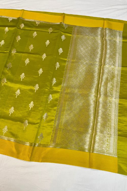 Green Raw Mango Silk Saree with satin border, buti motifs, zari aachal, and unstitched brocade blouse – handcrafted Banarasi silk saree.