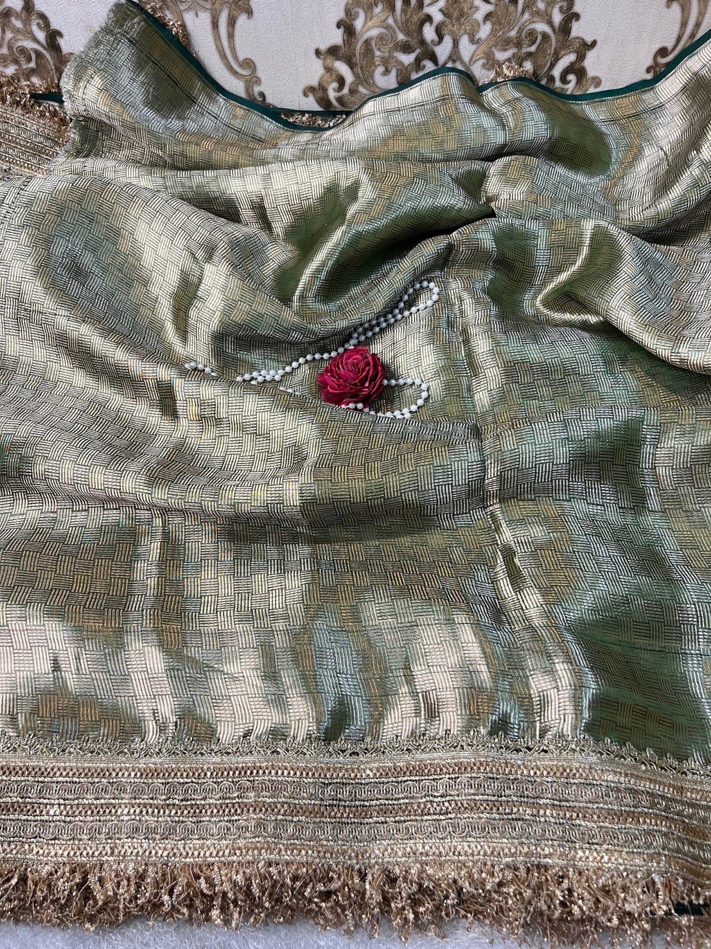 Emerald green Banarasi saree with hand embroidery of Varanasi ghats, boats, temples, and river scenes.