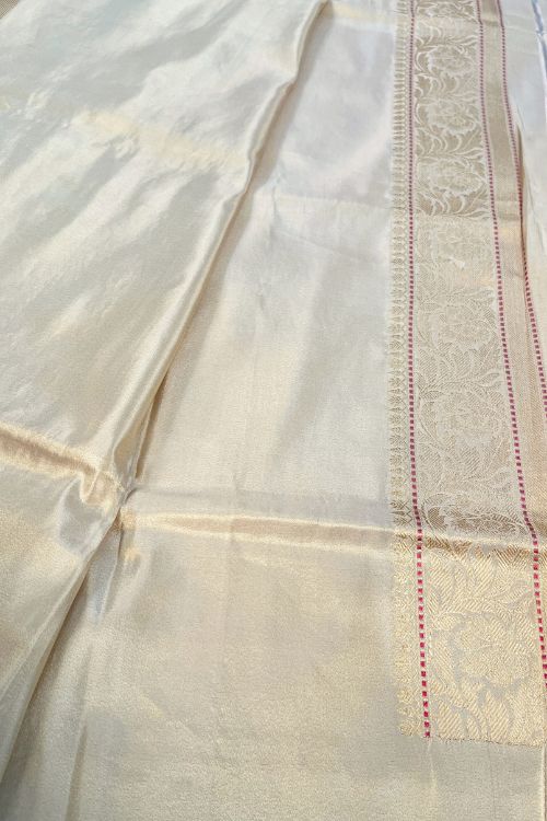 Beige Kora Tissue Pure Silk Saree with golden and silver zari butas and red contrast selvedge border