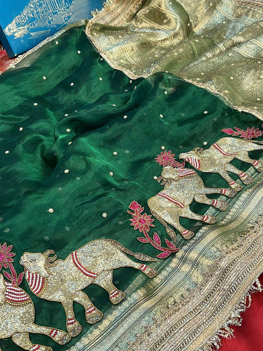 Manatavya Banaras bottle green Pichwai pure Banarasi tissue silk saree featuring intricate Pichwai motifs, rich zari work and regal festive elegance