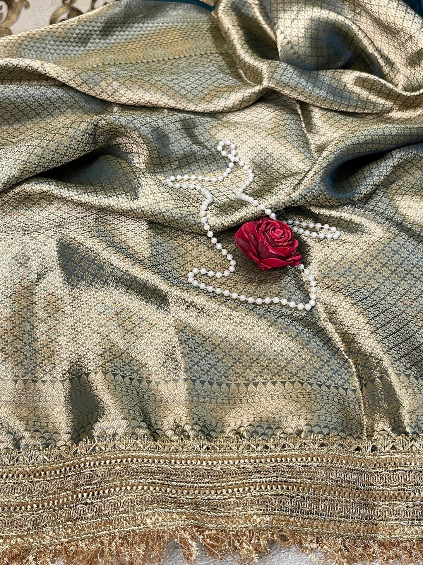 Blue Tissue Silk Saree with hand-embroidered Nazar motif featuring Om, lotus, floral, and moon designs in zari and threadwork