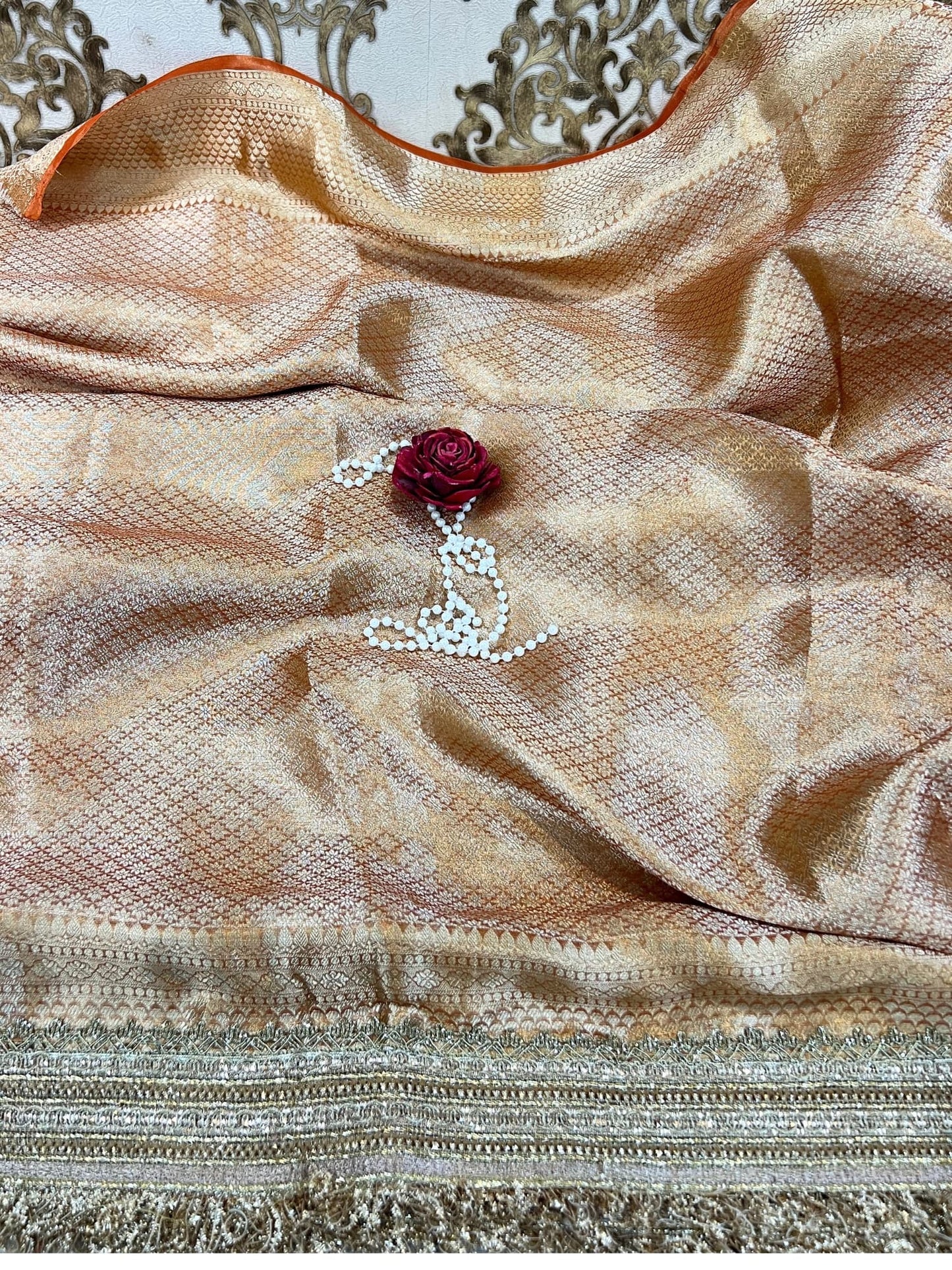 Pastel orange Gajraaj hand-embroidered tissue silk saree