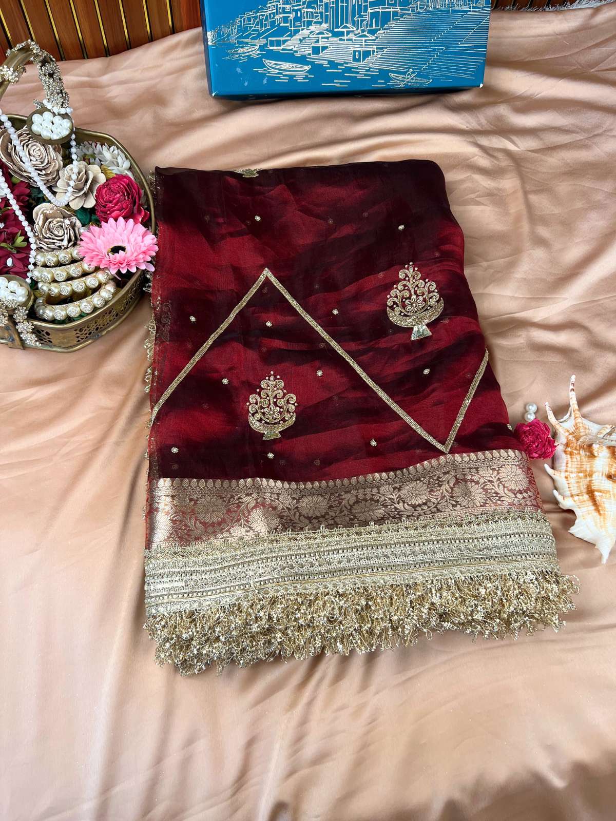 Manatavya Banaras deep maroon Gulzaar tissue silk saree with intricate floral weaving, gold zari highlights and traditional festive elegance