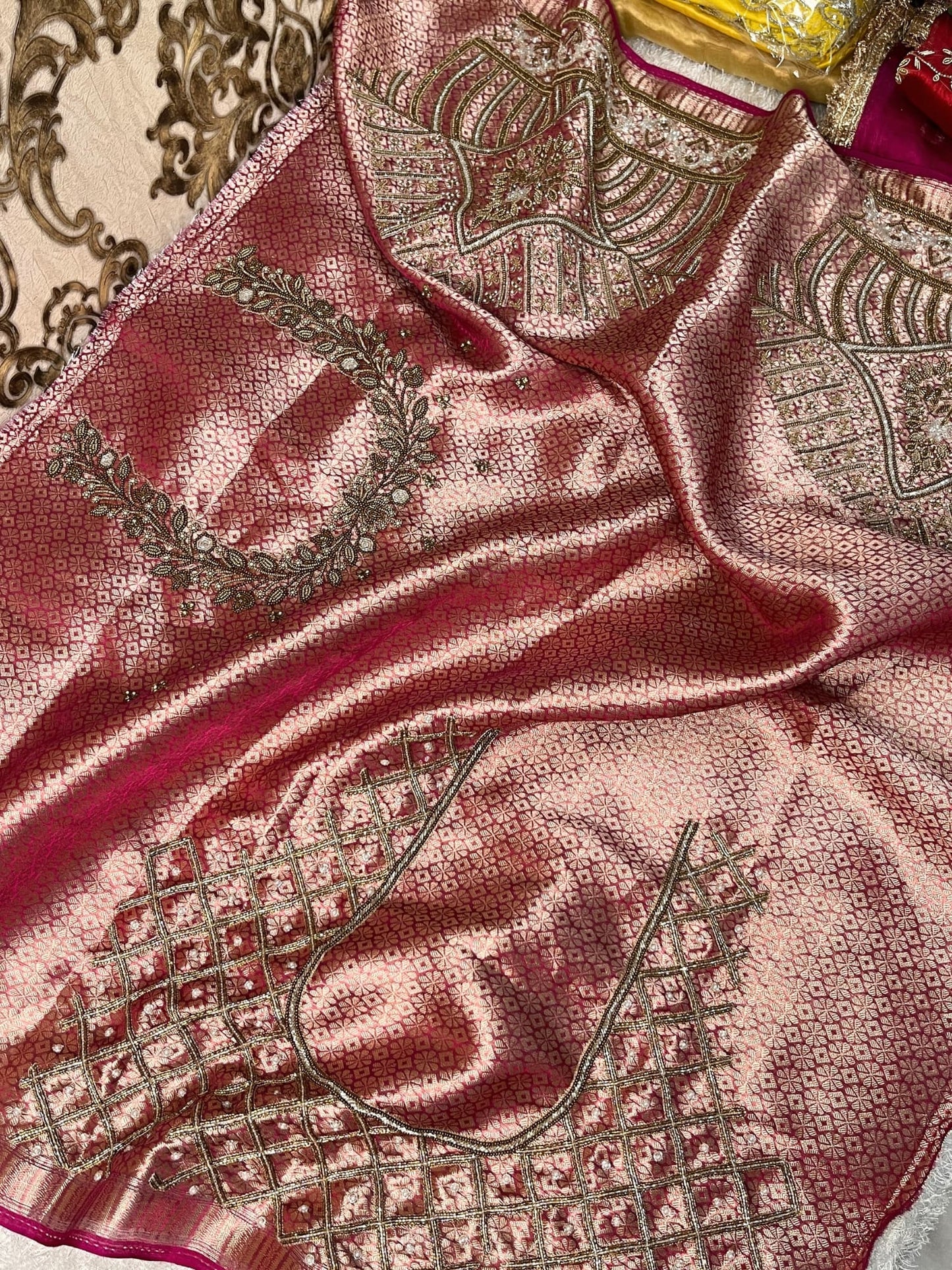 Hand-embroidered pink tissue silk saree featuring zari paisley motifs and a rich golden border by Mantavya Banaras