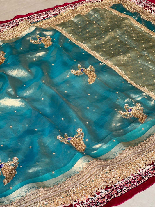 Manatavya Banaras powder blue Mayur saree with intricate peacock motifs, lightweight drape and traditional festive elegance