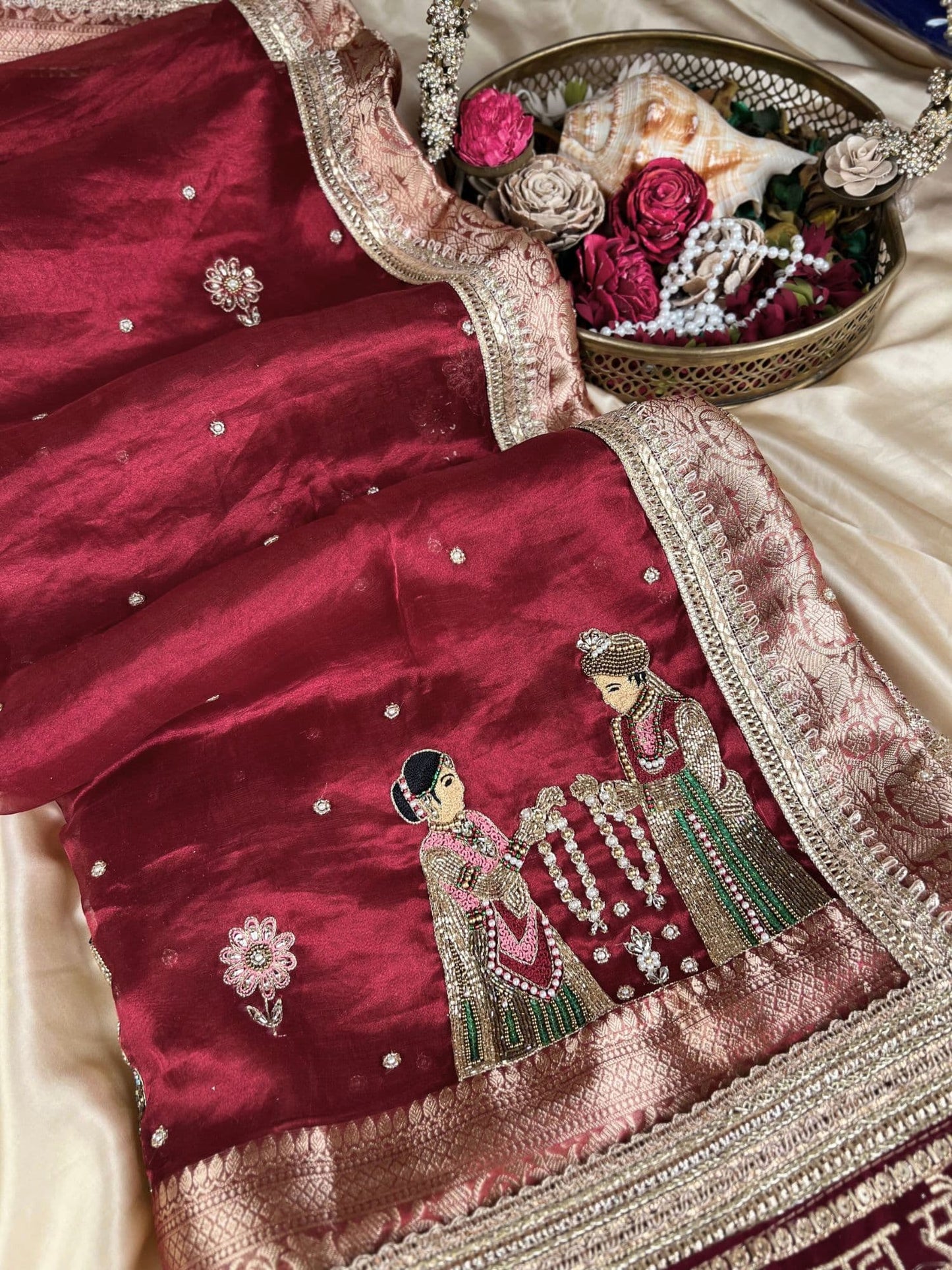 Manatavya Banaras maroon Varmala pure Banarasi tissue silk saree with intricate zari weaving, traditional floral motifs and elegant bridal design