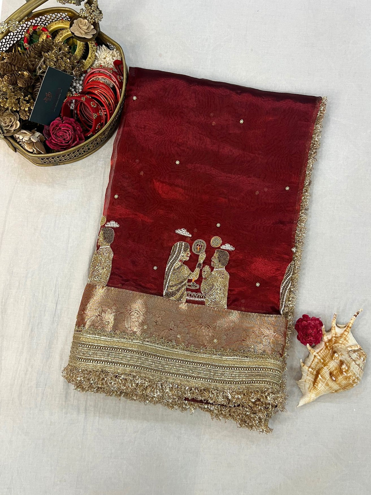 “Maroon Karwa Chauth saree with festive detailing”