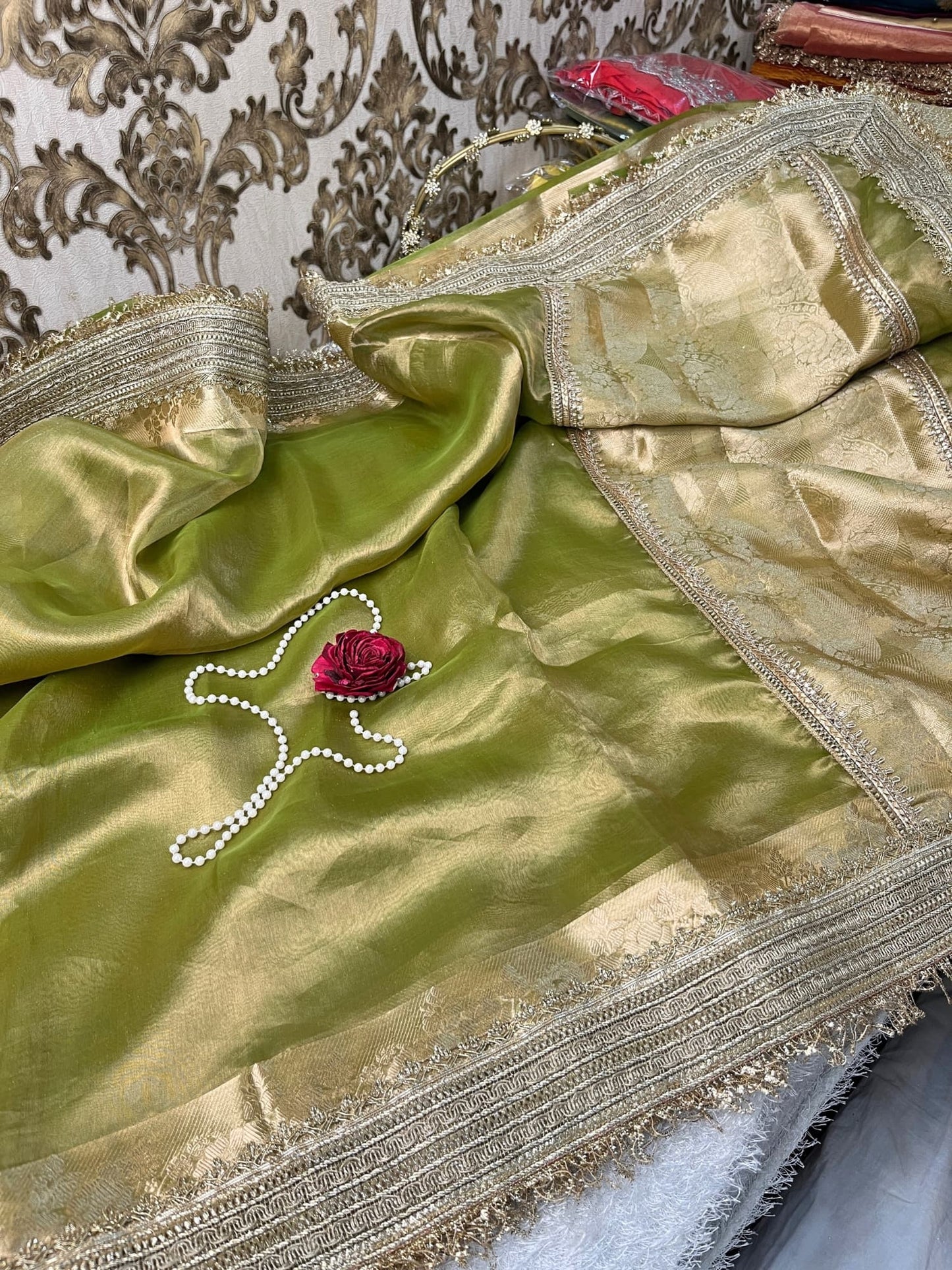 Pista green pure Banarasi tissue silk saree featuring gota patti border, rich brocade aachal, and unstitched brocade blouse piece, handwoven in Varanasi.
