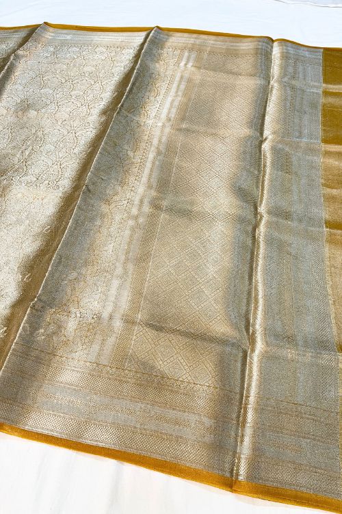 Yellow Brocade Tissue Silk Saree with Silver Zari and Unstitched Blouse showcasing intricate traditional design