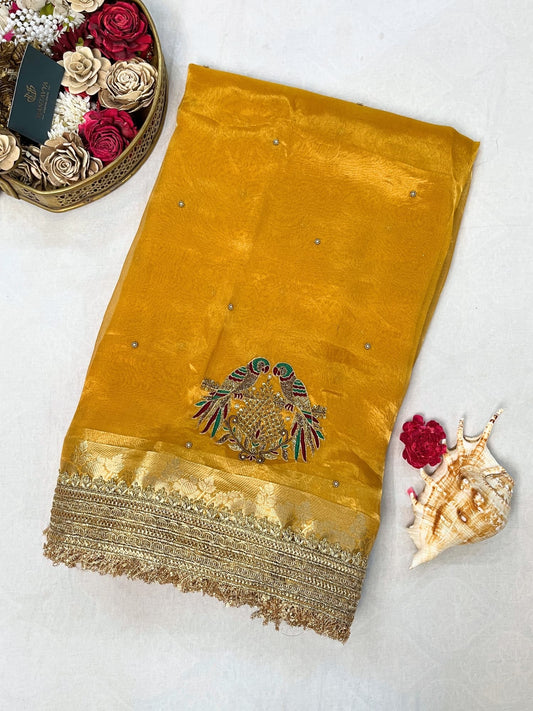 Yellow Tissue Silk Saree with hand-embroidered double parrot and leaf motifs, paired with a brocade blouse