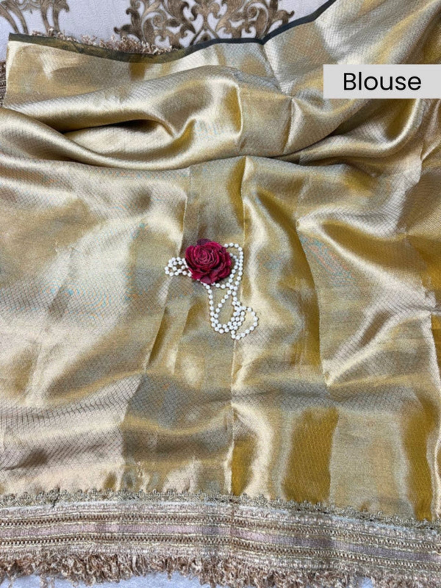 Gold blouse with a red flower and pearl detail, labeled 'Blouse'.