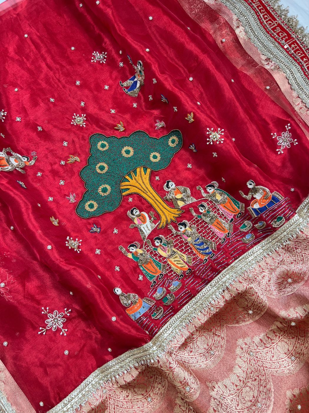 Royal Red tissue silk saree with zari border and traditional closeup view