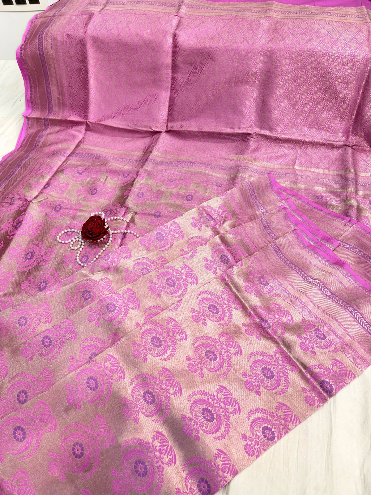 “Pink Katan Silk saree with elegant weaving and festive design”