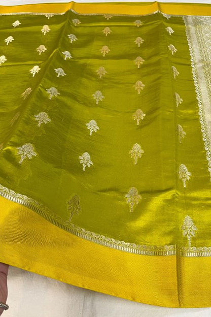 Green Raw Mango Silk Saree with satin border, buti motifs, zari aachal, and unstitched brocade blouse – handcrafted Banarasi silk saree.