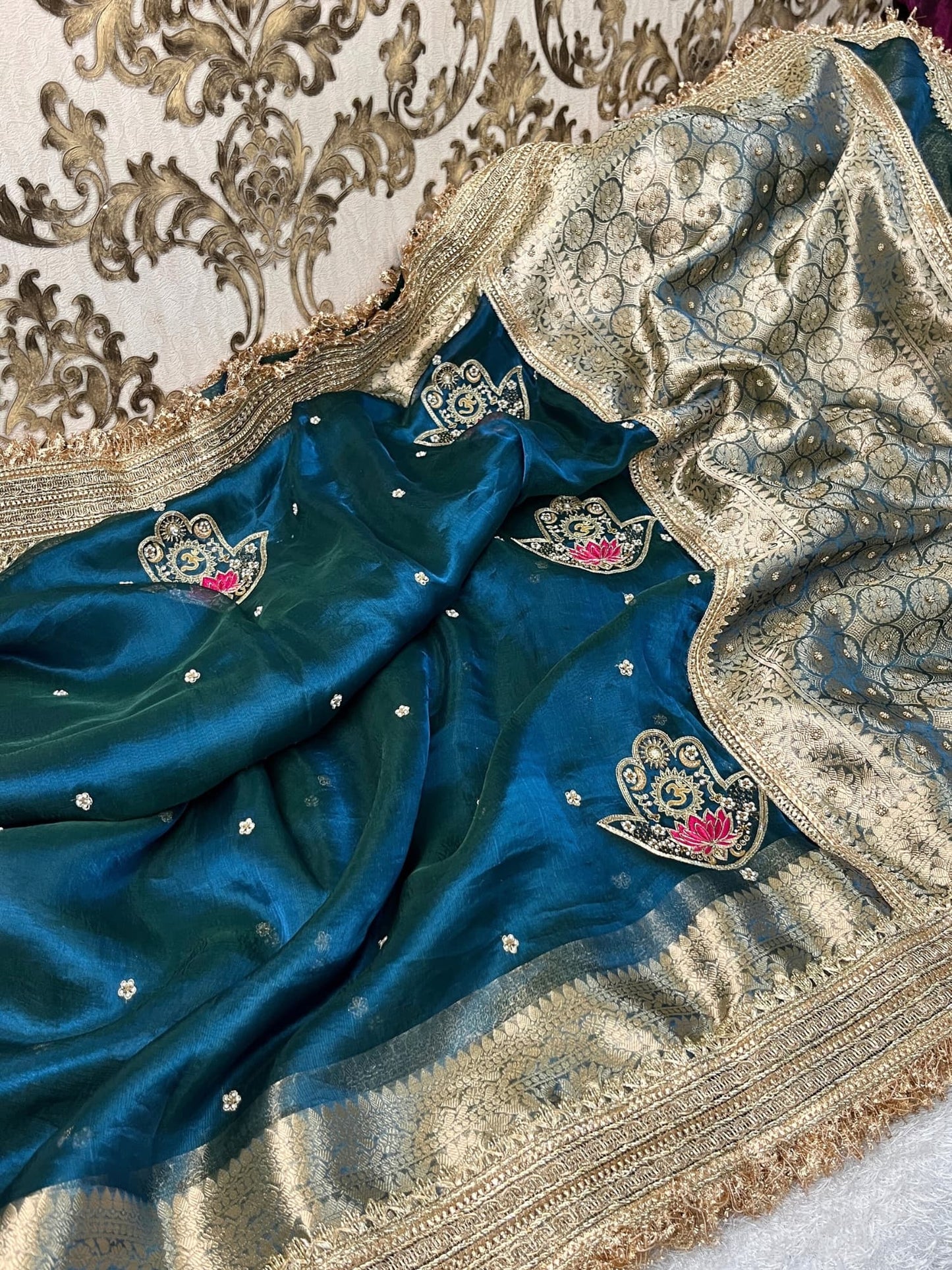Blue Tissue Silk Saree with hand-embroidered Nazar motif featuring Om, lotus, floral, and moon designs in zari and threadwork
