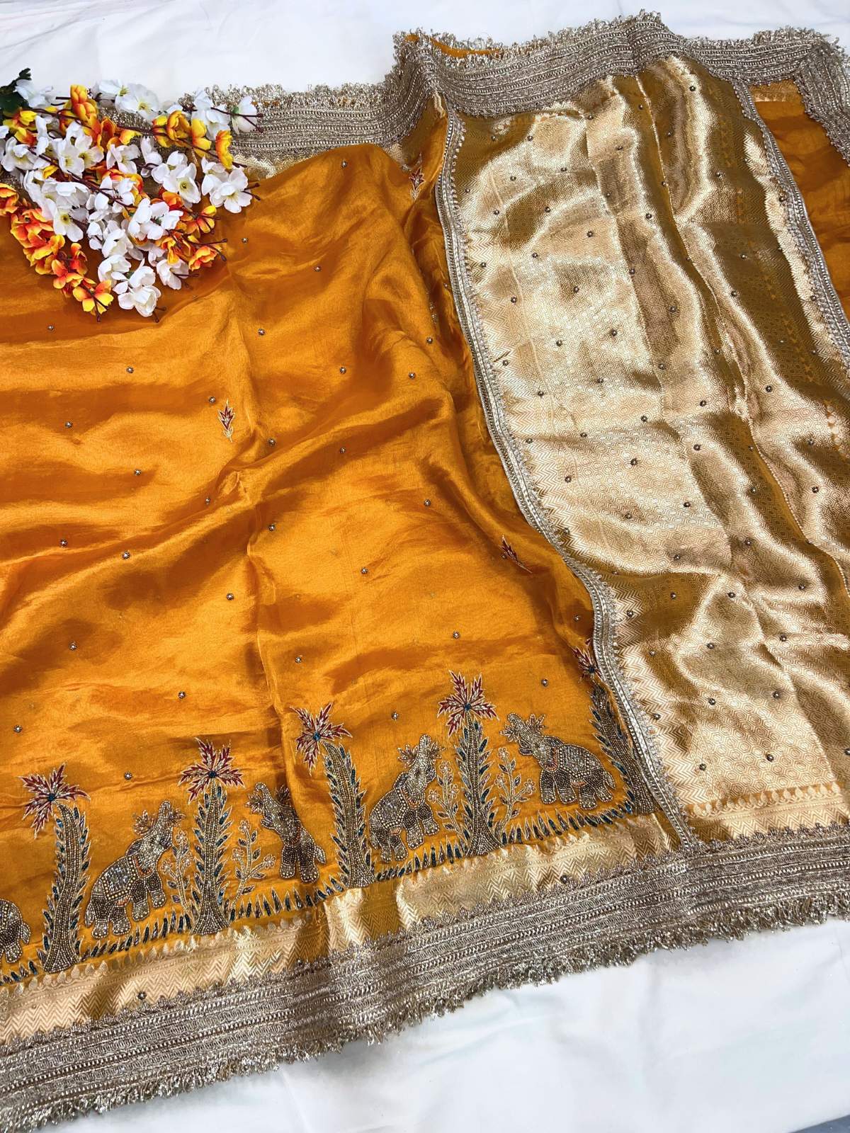 Orange Gajgamini Banarasi silk saree blouse inspired by royal elephant motifs