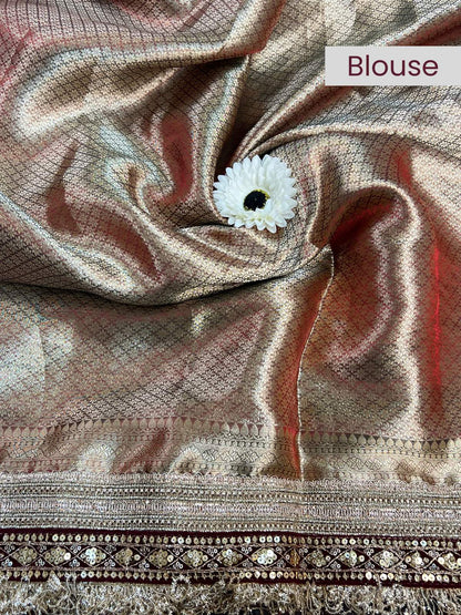 Close-up of a blouse fabric with a white flower pin, labeled 'Blouse'.