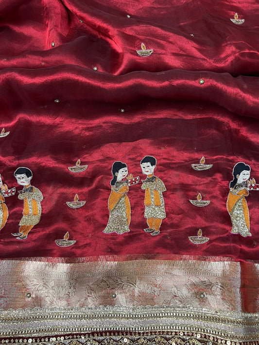 “Maroon Diwali saree with intricate traditional embroidery for festive celebrations”