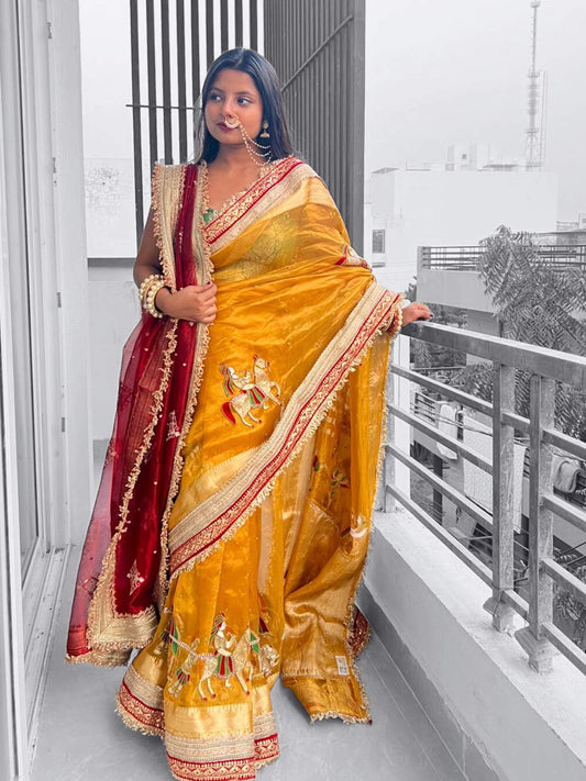 “Mustard Yellow Saat Vachan Banarasi silk saree with wedding motifs and festive embroidery”