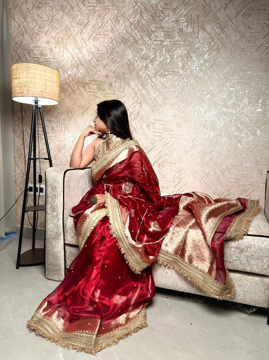 Manatavya Banaras deep maroon Gulzaar tissue silk saree with intricate floral weaving, gold zari highlights and traditional festive elegance