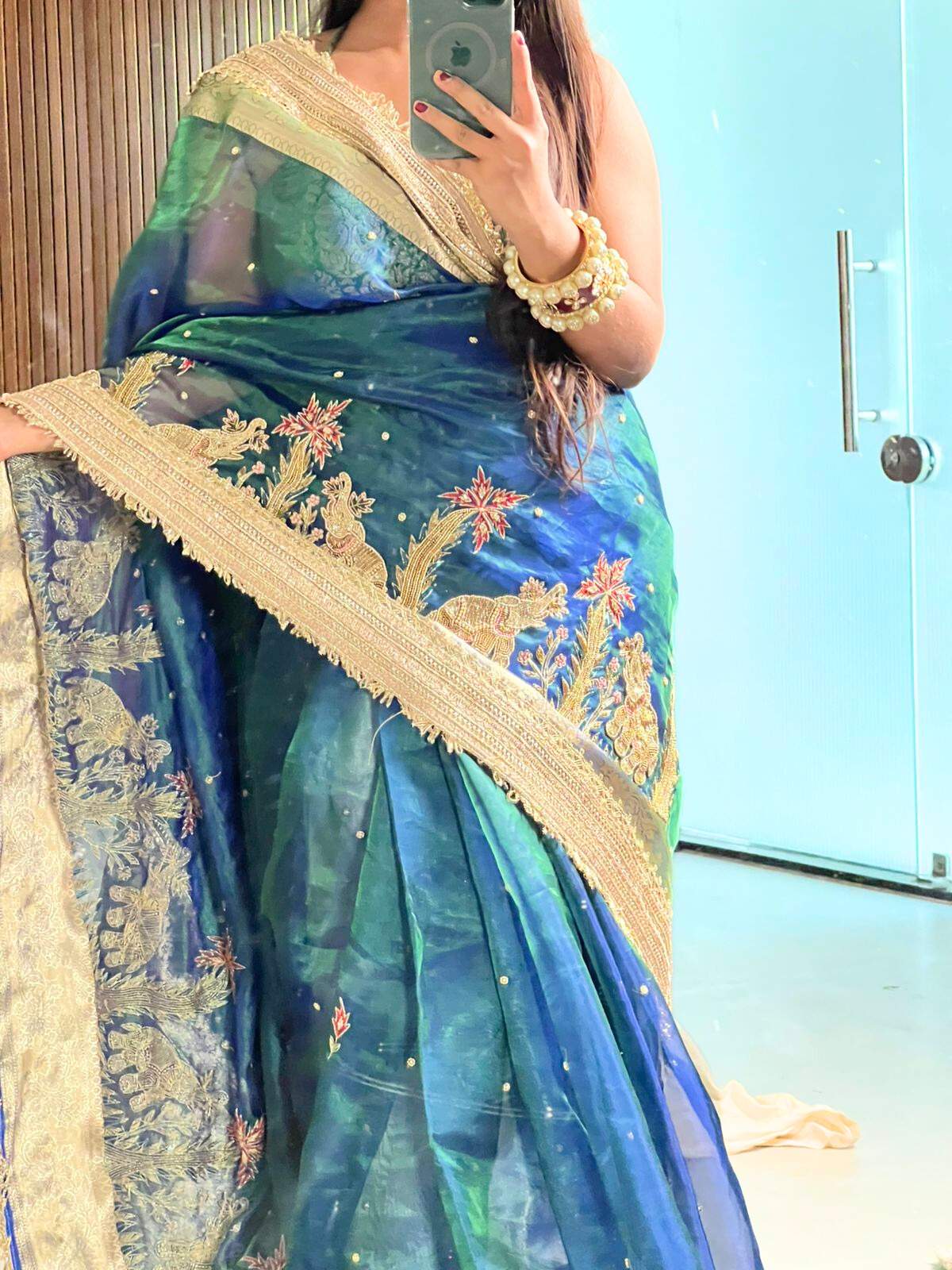 “Peacock Teal Blue Gajgamini saree with intricate embroidery and festive design”