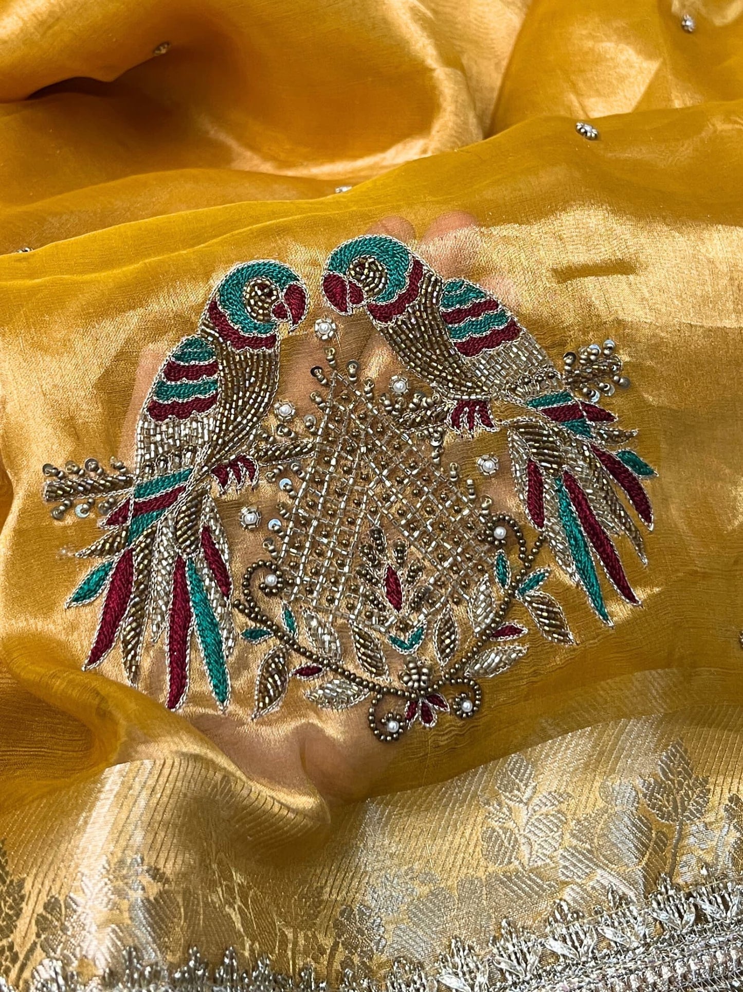 Yellow Tissue Silk Saree with hand-embroidered double parrot and leaf motifs, paired with a brocade blouse