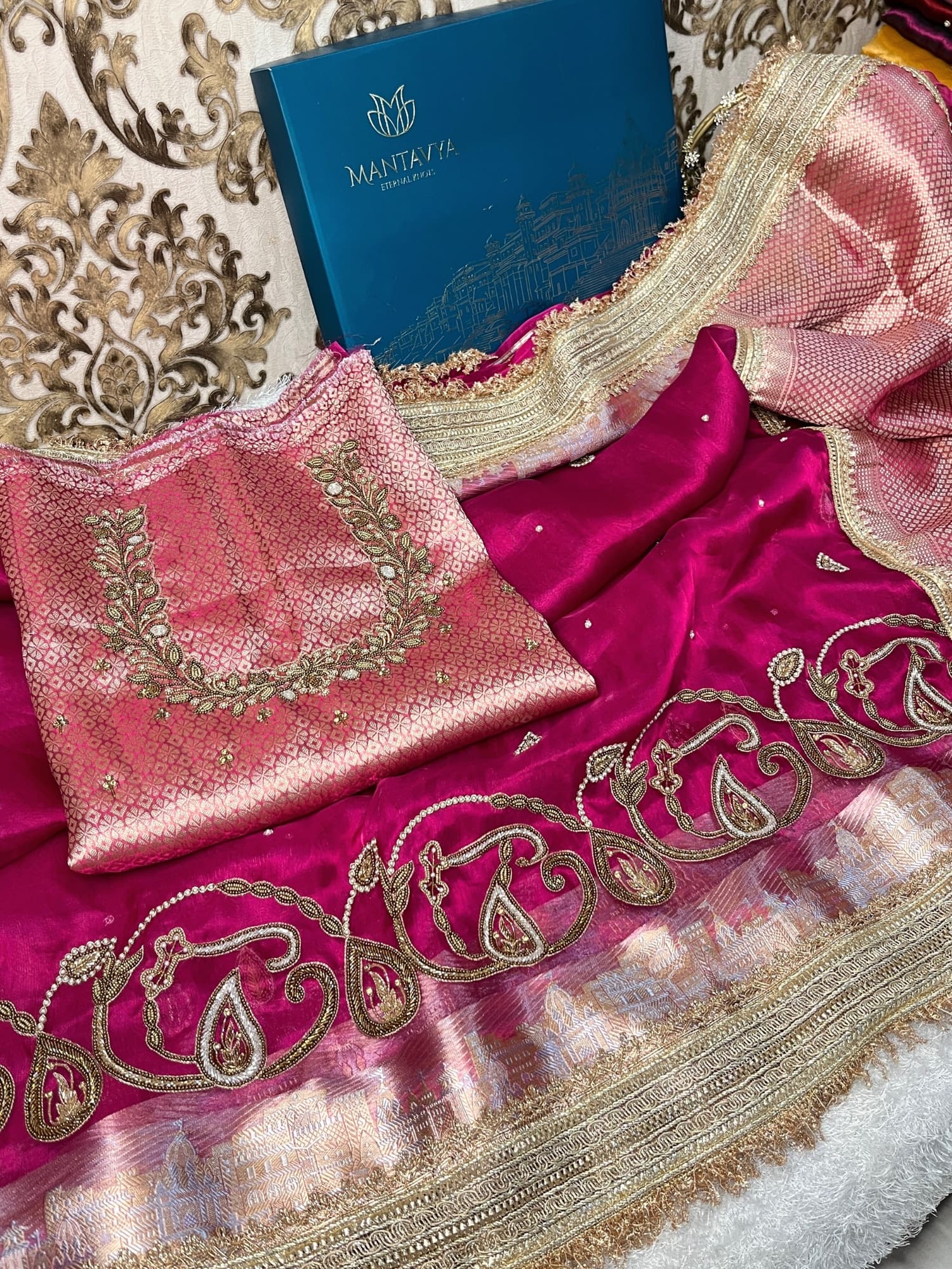 Hand-embroidered pink tissue silk saree featuring zari paisley motifs and a rich golden border by Mantavya Banaras
