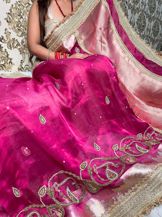 Hand-embroidered pink tissue silk saree featuring zari paisley motifs and a rich golden border by Mantavya Banaras