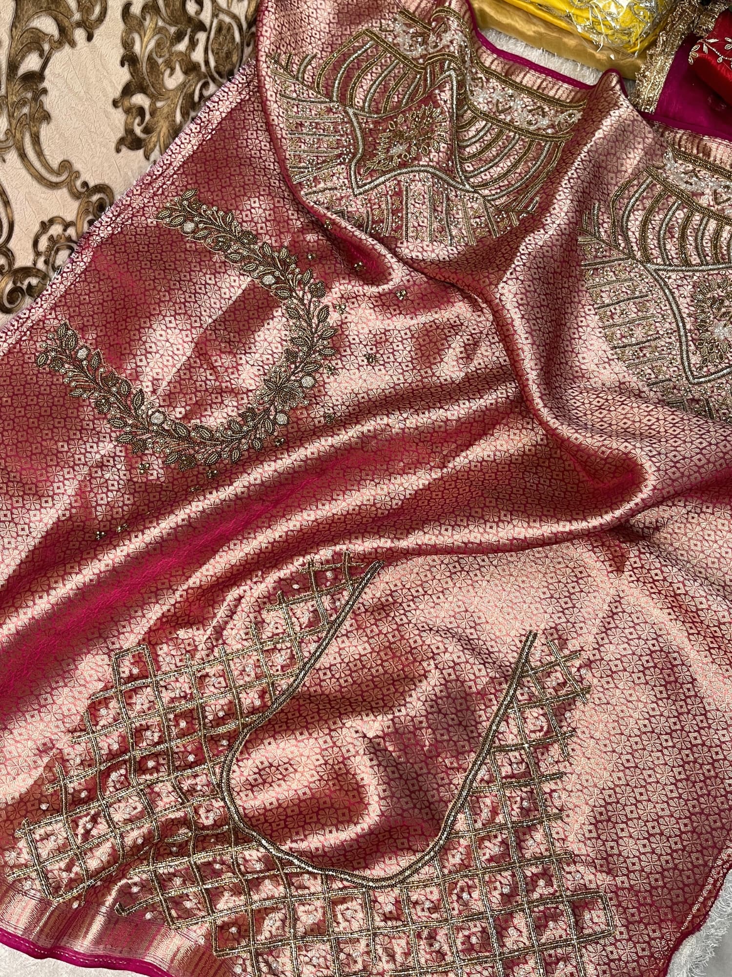 Hand-embroidered pink tissue silk saree featuring zari paisley motifs and a rich golden border by Mantavya Banaras