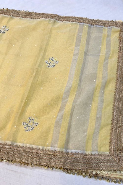 Hand-Embroidered Light Yellow Linen Tissue Silk Saree with Floral Motifs and Zari Lace Border