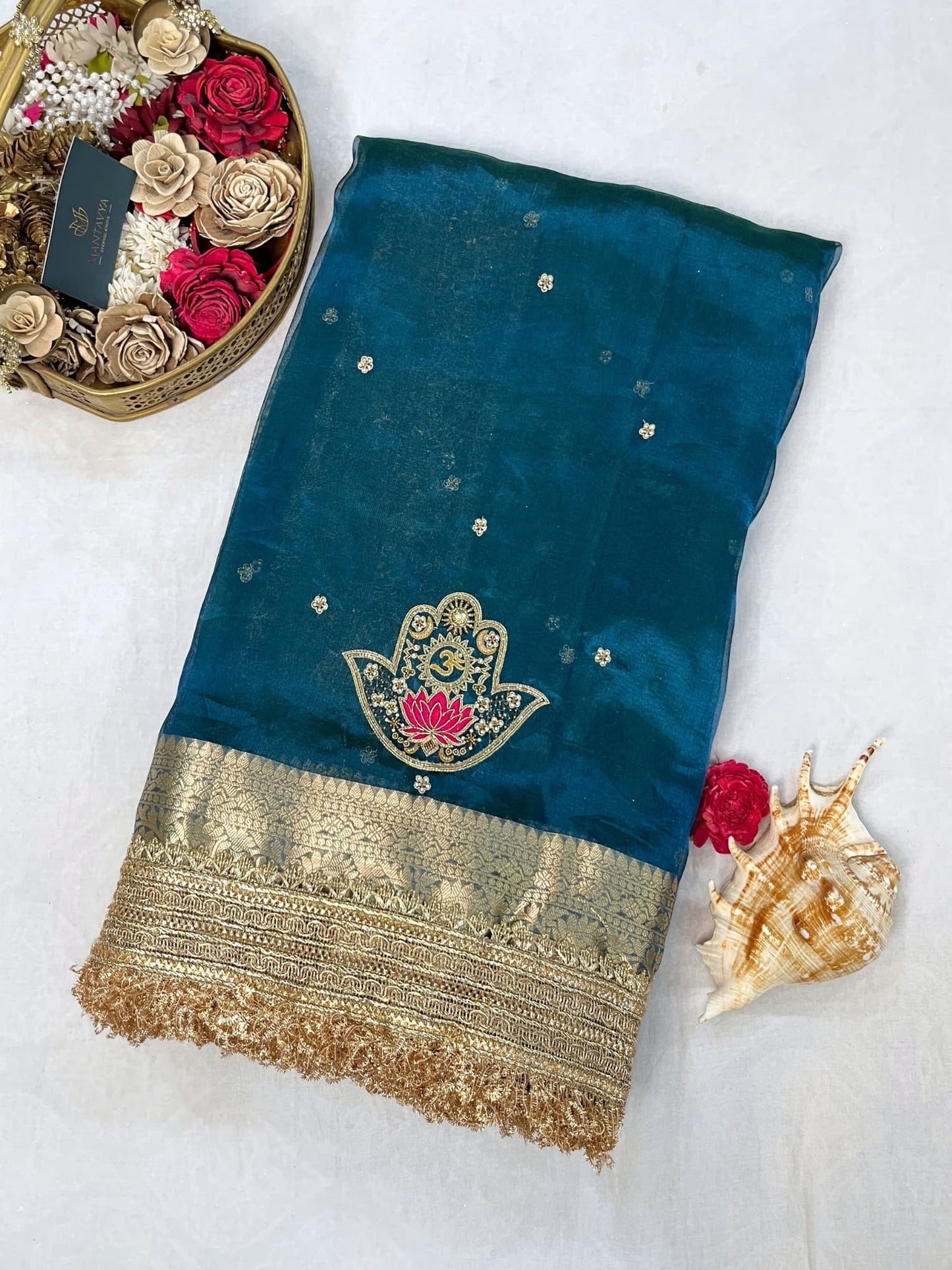 Blue Tissue Silk Saree with hand-embroidered Nazar motif featuring Om, lotus, floral, and moon designs in zari and threadwork