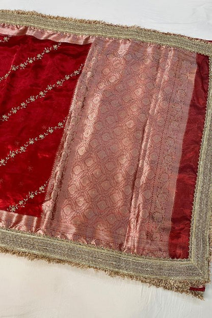 Red hand embroidered tissue silk saree with diagonal stripes and floral buti, paired with brocade blouse with hand embroidery on neck and sleeves.
