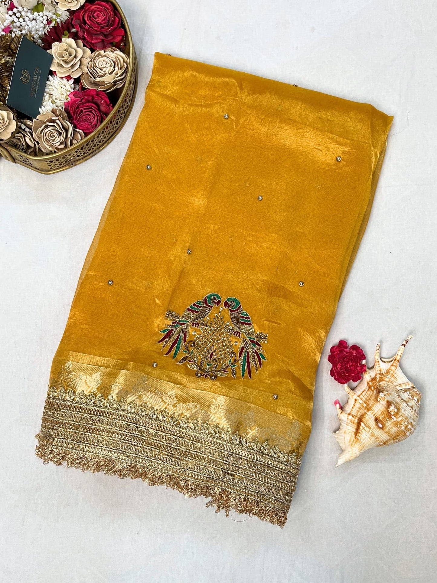 Yellow Tissue Silk Saree with hand-embroidered double parrot and leaf motifs, paired with a brocade blouse