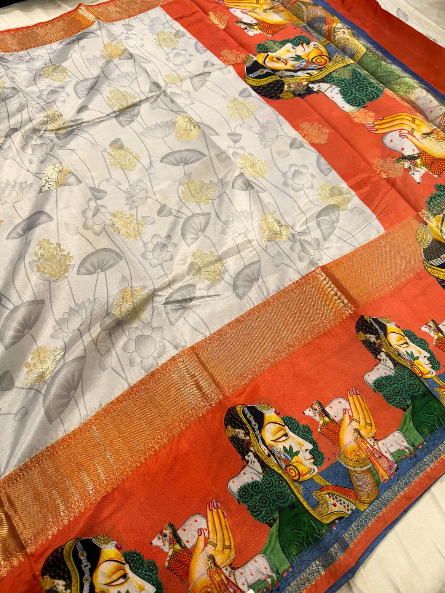 Light grey saree with an orange border and intricate central design – mantavya banaras