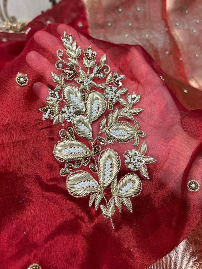 Hand Embroidered Red Banarasi Tissue Silk Saree with flower buta, gota patti border, brocade aachal, and unstitched brocade blouse piece