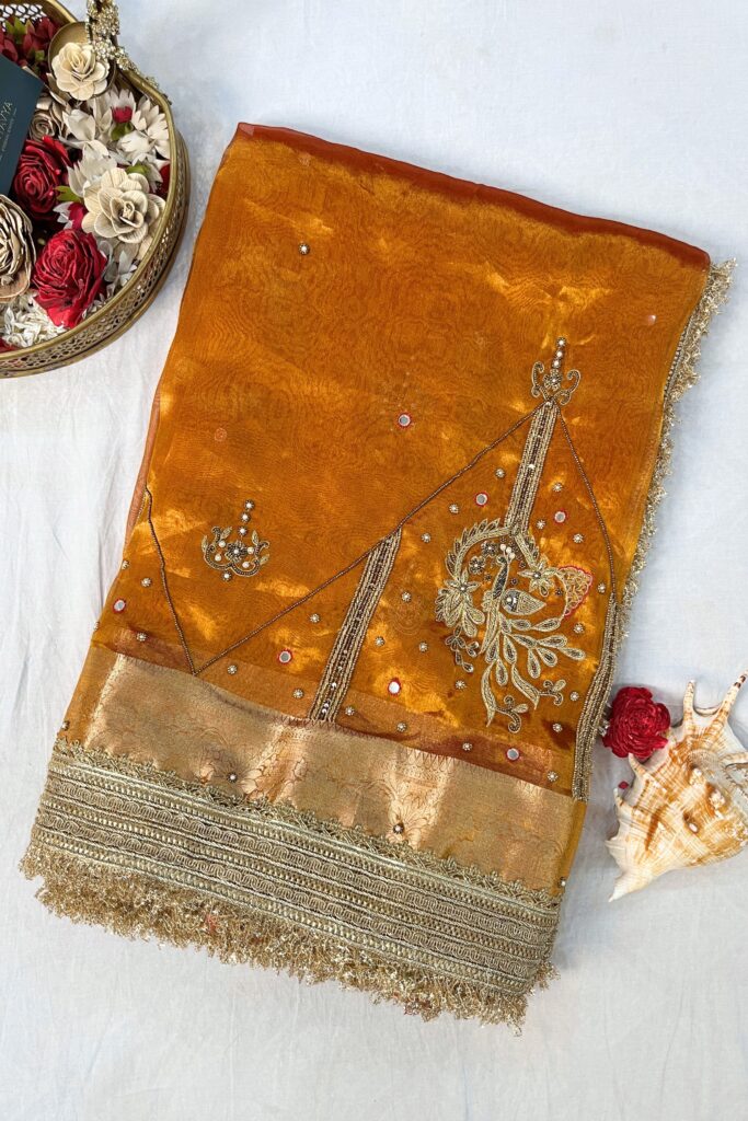 Gold Hand Embroidered Kanjivaram Tissue Silk Saree featuring intricate peacock motifs and unstitched brocade blouse, ideal for weddings and rituals.