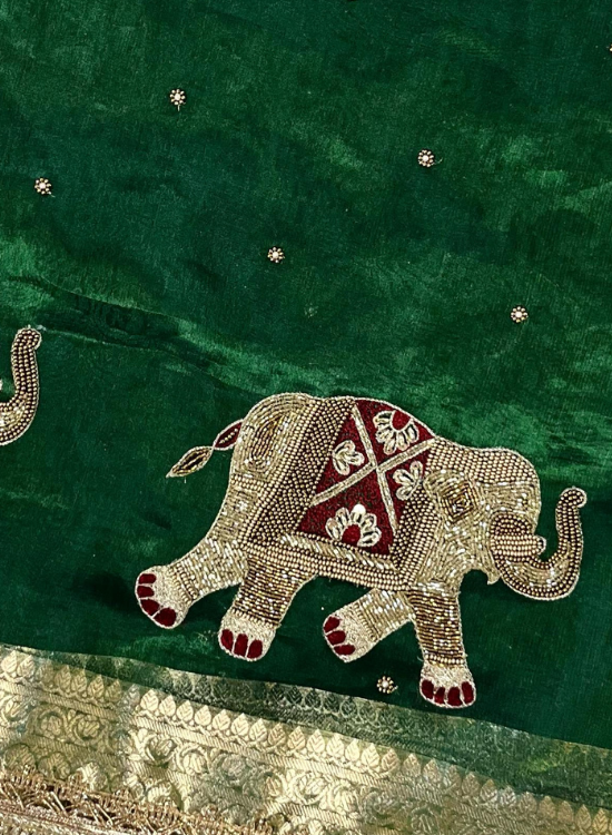Hand-embroidered Banarasi tissue silk saree with elephant motifs and gota patti border, perfect for weddings and festive occasions.