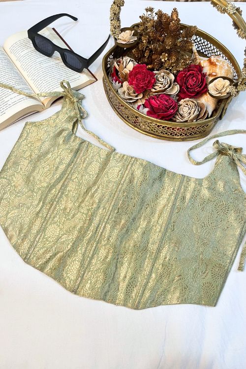 Handwoven Banarasi silk corset top in sage green featuring gold zari, boning details, and structured square neck design.