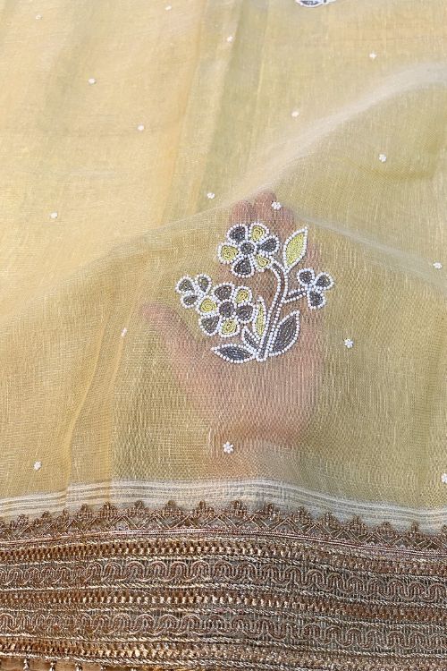 Hand-Embroidered Light Yellow Linen Tissue Silk Saree with Floral Motifs and Zari Lace Border