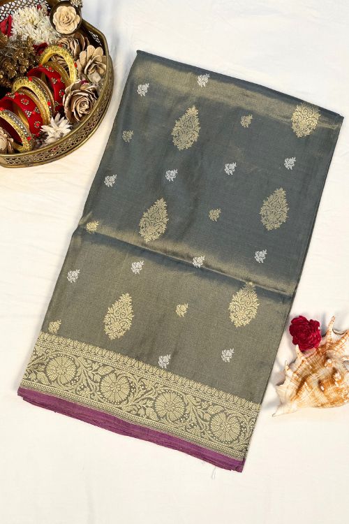 Grey Kora Tissue Silk Saree with gold and silver zari, Mughal floral border, and purple contrast selvedge – handwoven Banarasi saree.