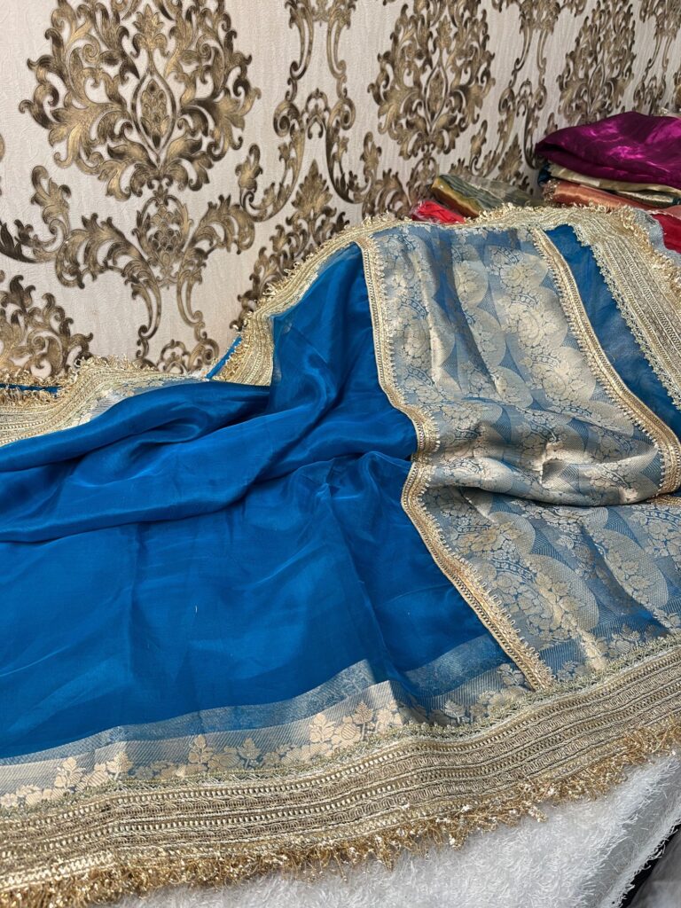 Blue pure Banarasi tissue silk saree with gota patti border, brocade aachal, and matching unstitched brocade blouse piece.