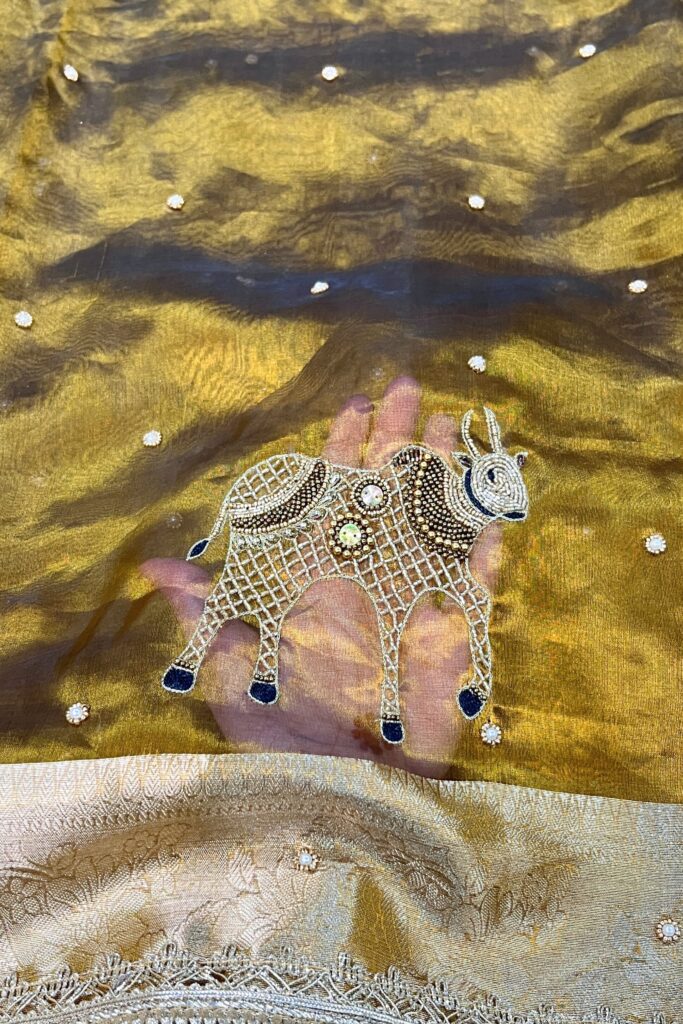 Hand Embroidered Mehndi Green Banarasi Tissue Silk Saree with Nandi buta and intricate detailing, perfect for weddings and festive occasions.