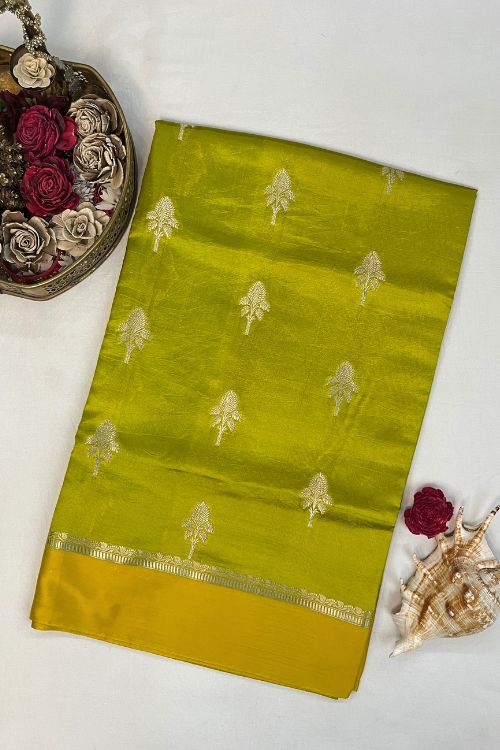 Green Raw Mango Silk Saree with satin border, buti motifs, zari aachal, and unstitched brocade blouse – handcrafted Banarasi silk saree.