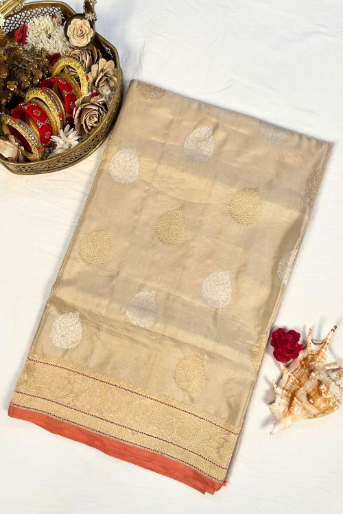 Beige Kora Tissue Pure Silk Saree with golden and silver zari butas and red contrast selvedge border