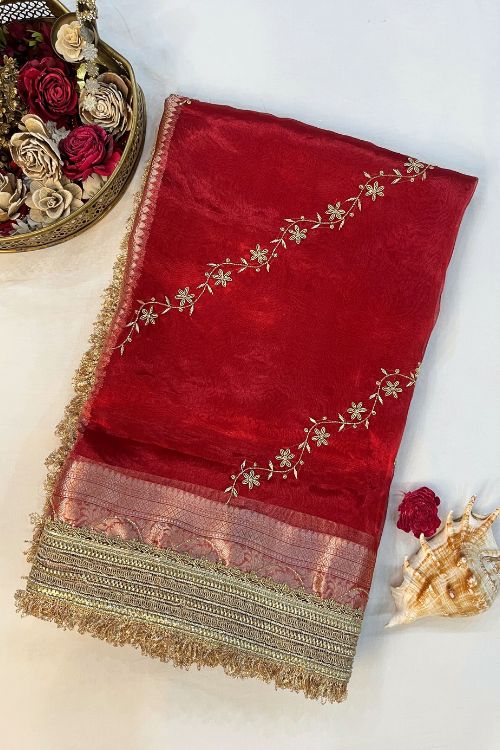 Red hand embroidered tissue silk saree with diagonal stripes and floral buti, paired with brocade blouse with hand embroidery on neck and sleeves.