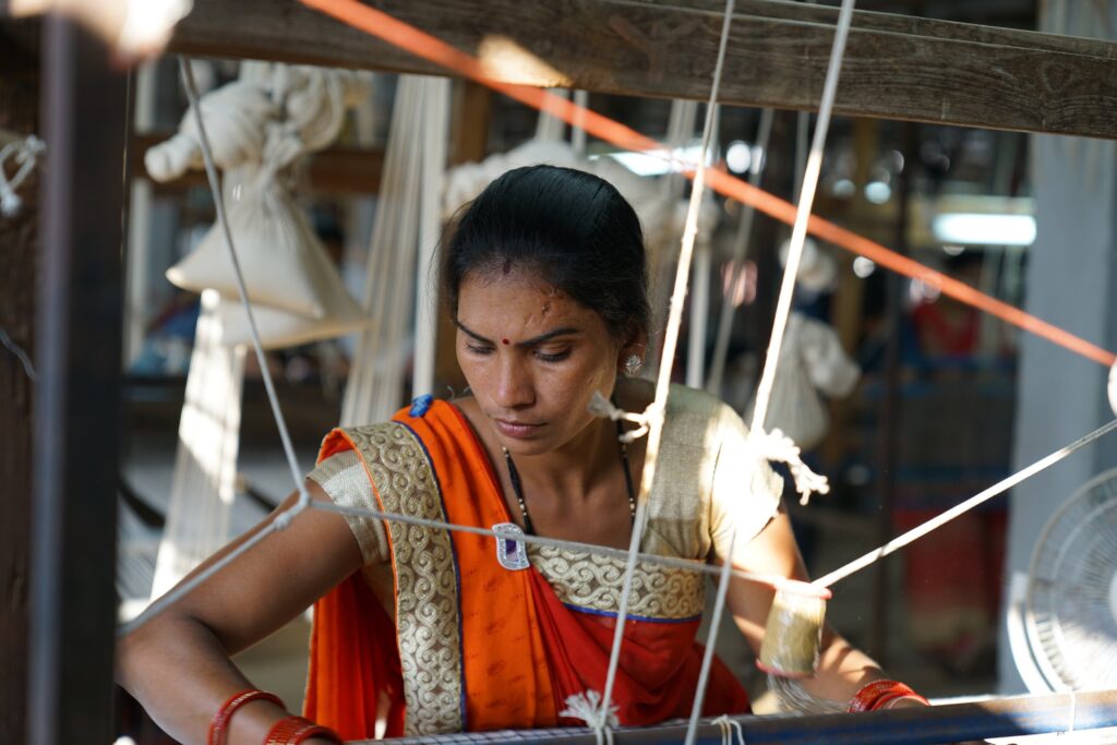 A woman in the midst of the weaving process.